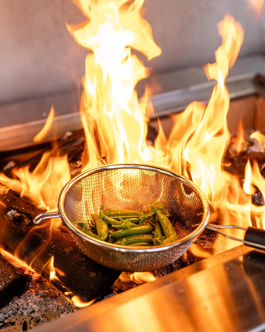 Vegetables cooking over an open flame at BlackBrick