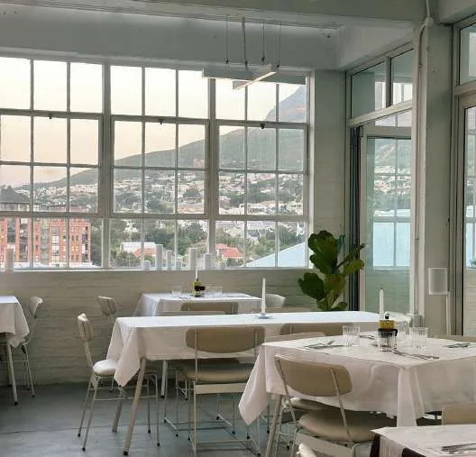 Briquette's dining room with the city and mountain through the windows