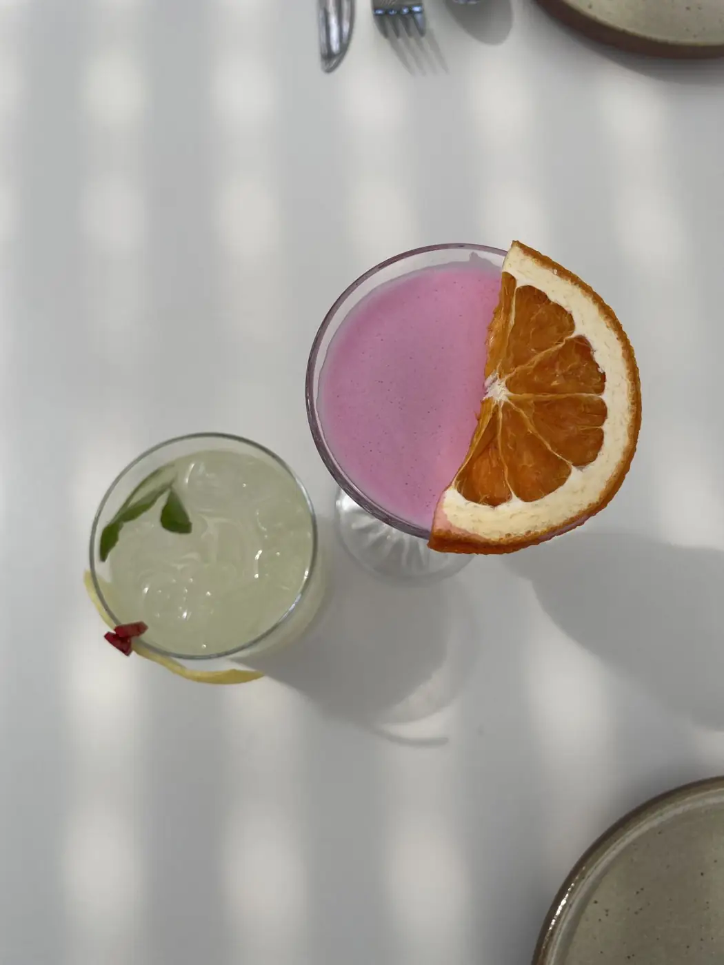 A pink sour with dried orange